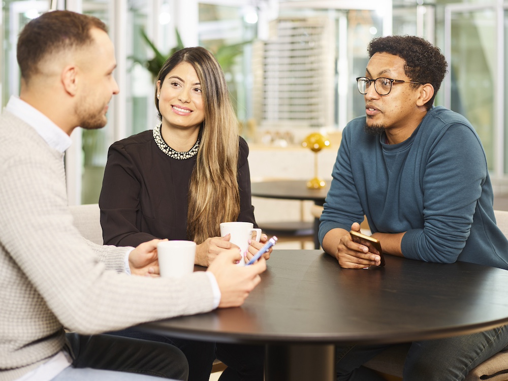 Three Rapport ambassadors sitting at a table