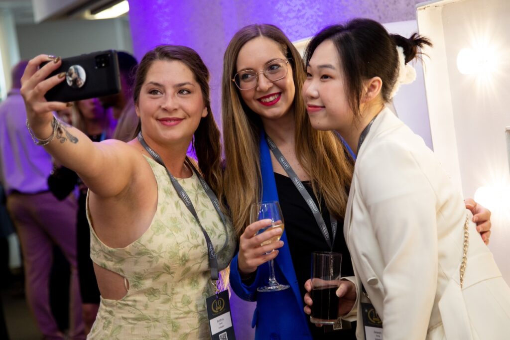 Three Rapport ambassadors taking a selfie at a social event